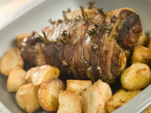 mouthwatering rosemary & garlic roast lamb paired with roast potatoes and peas